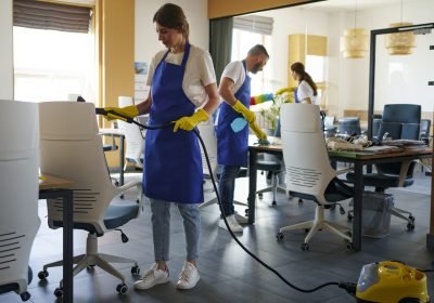 professional cleaning service person using vacuum cleaner office